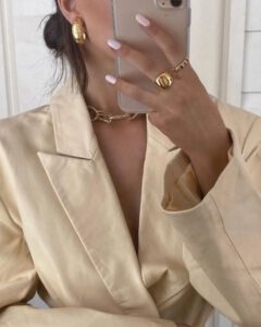 gold jewelry on a blazer outfit
